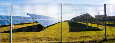 Solar panels against mountains landscape and blue sky