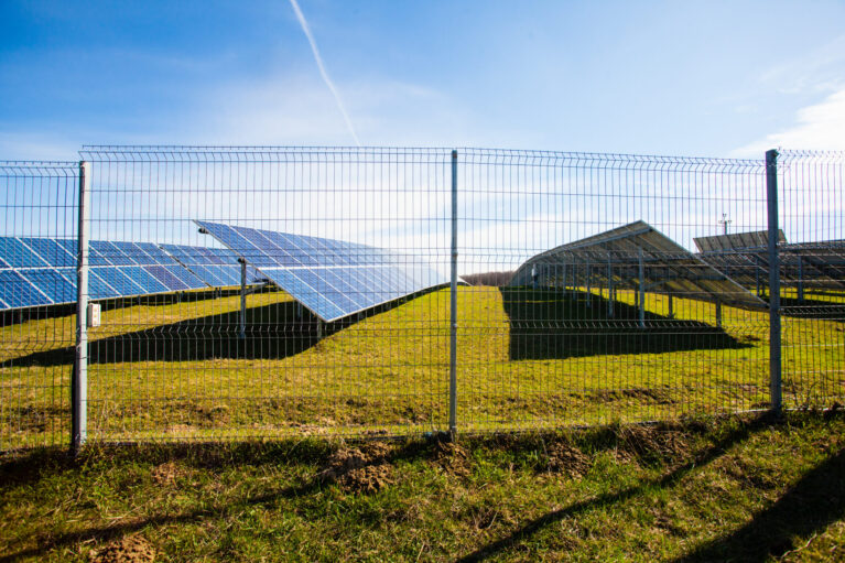 Solar panels against mountains landscape and blue sky