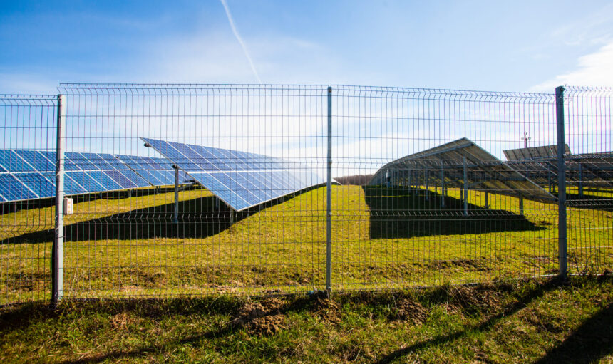 Solar panels against mountains landscape and blue sky