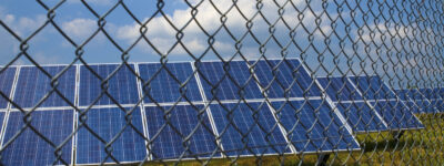 Solar panels behind rusty fence in the field near Sofia