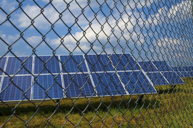 Solar panels behind rusty fence in the field near Sofia