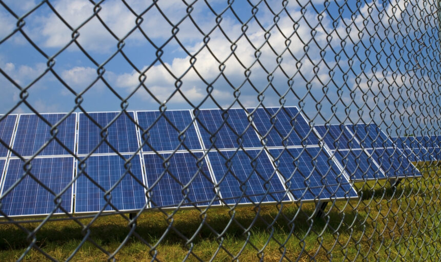 Solar panels behind rusty fence in the field near Sofia